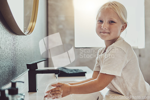 Image of Bathroom, water and portrait of child washing hands with soap, foam and healthy hygiene. Cleaning dirt, germs and bacteria on fingers, happy girl in home for morning wellness, safety and skin care.