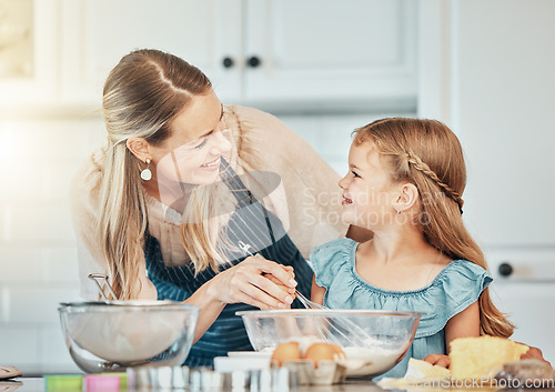 Image of Happy woman in kitchen, baking together with child and teaching, learning and nutrition with mother. Smile, mom and girl kid helping make cookies in home with care, support and love at breakfast.