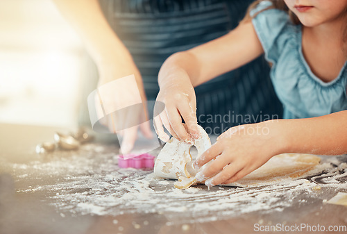 Image of Hands, baking and parent help child with cooking in a home kitchen learning to prepare cookies or biscuits recipe. Development, table and mother teaching kid a food hobby in a house together