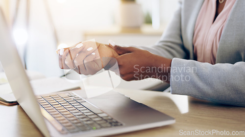 Image of Woman, laptop and hands with wrist pain, injury or carpal tunnel syndrome by office desk. Closeup of female person or employee with sore muscle, ache or joint inflammation from arthritis or strain