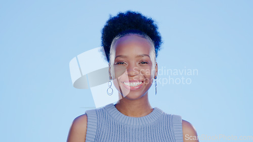 Image of Smile, happy and portrait of black woman in a studio with positive, confident and good attitude. Excited, pride and young African female model with joy and happiness isolated by blue background.