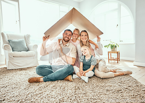 Image of Happy family, portrait and cardboard roof for moving in, property investment or real estate at new home. Mother, father and kids smile for shelter, apartment or relocation together on house mortgage