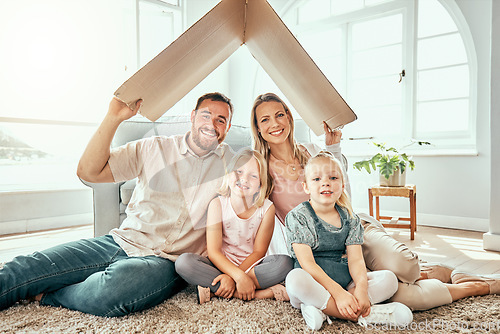 Image of Happy family, portrait and cardboard roof for real estate, moving in or property investment at new home. Mother, father and kids smile for shelter, apartment or relocation together on house mortgage