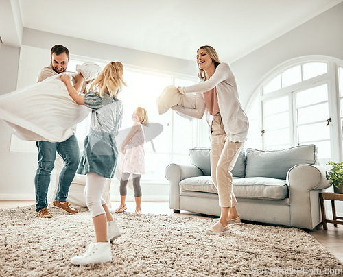 Image of Happy family, pillow fight and playing in living room together for fun holiday, weekend or bonding at home. Mother, father and children smile with cushion game, play or free time for summer break