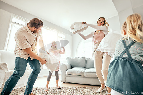 Image of Happy family, pillow fight and playing in living room for bonding, fun holiday or weekend together at home. Mother, father and children smile with cushion game, play or free time for summer break