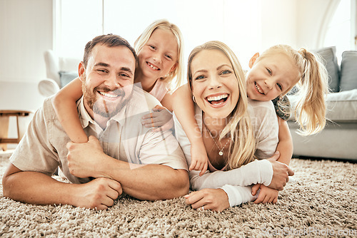 Image of Happy, smile and portrait of family in the living room bonding, hugging and relaxing together. Happiness, love and girl children laying with parents from Australia on floor in lounge at modern home.