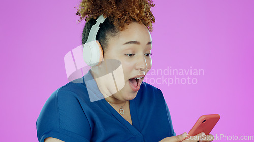 Image of Woman, phone and wow with headphones for winner, promotion or announcement in studio on purple background. Smartphone, person and surprised for notification, sale and lottery news with mock up space