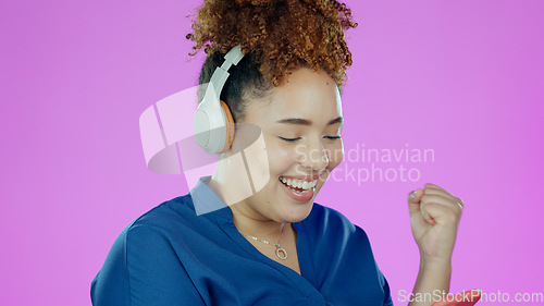 Image of Woman, phone and happy fist with headphones for winner, promotion or announcement in studio on purple background. Smartphone, person and excited for notification, sale and lottery with mock up space