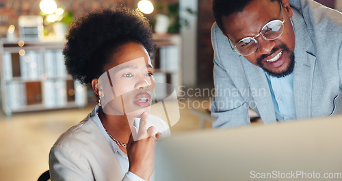 Image of Collaboration, problem solving and a mentor with an employee in the office at night for project management. Computer, teamwork or planning with a confused business man and woman working together