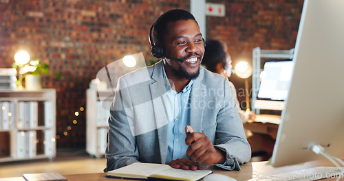 Image of African man, call center and computer in office, talk and night for telemarketing, voip mic and contact us. Consultant, crm and tech support agent for customer service, idea or questions at help desk
