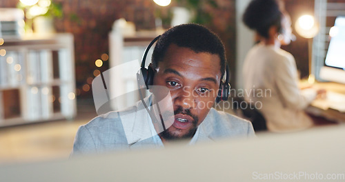 Image of African man, call center and computer for talk, thinking or night for telemarketing, voip mic or contact us. Consultant, crm and tech support agent for customer service, idea or solution at help desk