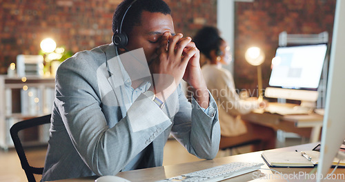 Image of African man, call center and stress by computer, tired or mistake for tech support, glitch or error. Consultant, crm or agent in night, telemarketing or customer service with fatigue, burnout or fail