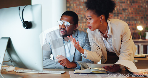 Image of Collaboration, confused and a mentor with an employee in the office at night for project management. Computer, teamwork or planning with a problem solving business man and woman working together