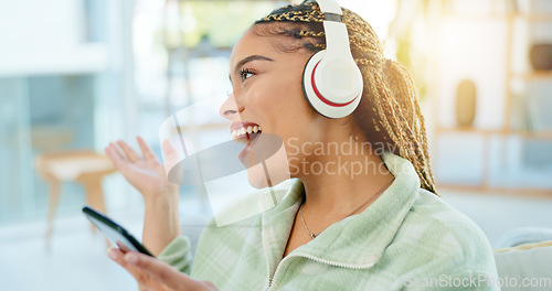 Image of Phone, singing and happy woman on music headphones in home living room. Smartphone, dance and excited African person listening to radio, audio and sound for freedom, celebration and streaming online