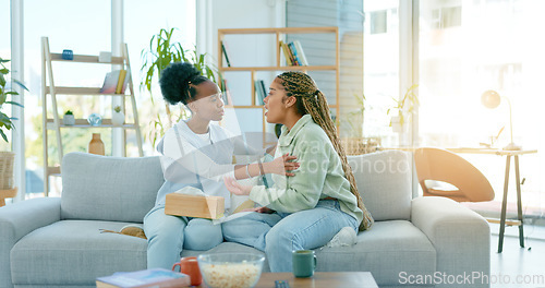 Image of Sad women, friends and support on sofa in home, care and conversation for anxiety. African girls, depression and comfort on couch for kindness, empathy and help to console in communication together