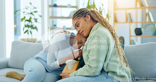 Image of Depression, empathy and support with black woman friends on a sofa in the living room of a home together. Sad, mental health and a young person crying into a tissue during loss, pain or grief