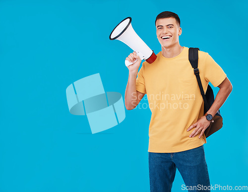 Image of Portrait, megaphone and man with a smile, announcement and promotion on a blue background. Person, activist and happy model with a bullhorn, change and happiness with justice, speech and mockup space
