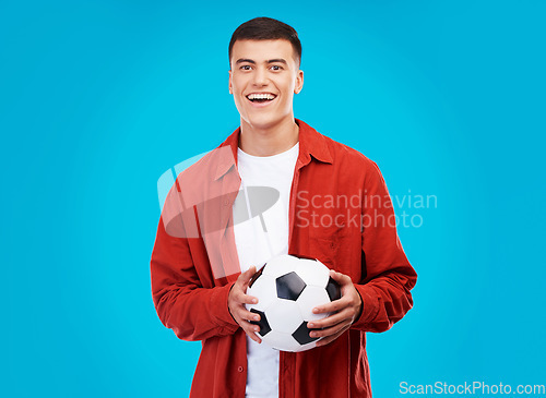Image of Soccer ball, happy and portrait of man on blue background for sports, winner and achievement. Smile, football fan and person cheer for team success, winning match, game and tournament in studio