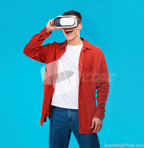 Image of Man, wow and VR or futuristic glasses for gaming software, digital world and fantasy vision on a blue background. Excited person watch in 3d video, virtual reality technology and metaverse in studio