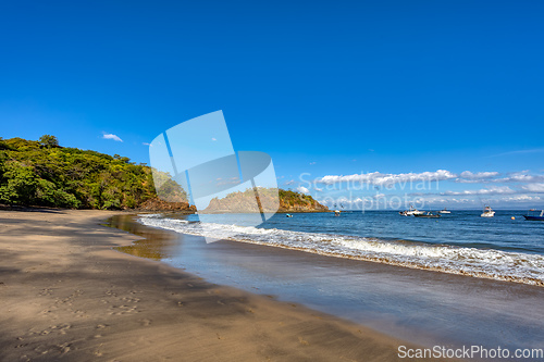 Image of Playa Ocotal and Pacific ocean waves on rocky shore, El Coco Costa Rica