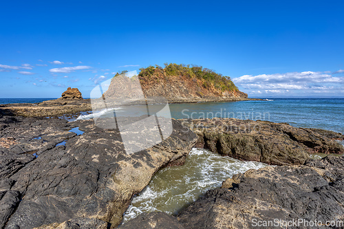 Image of Playa Ocotal and Pacific ocean waves on rocky shore, El Coco Costa Rica