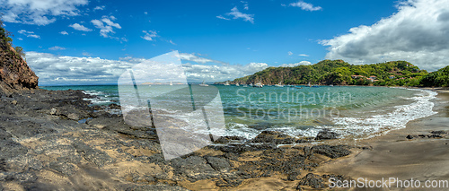 Image of Playa Ocotal and Pacific ocean waves on rocky shore, El Coco Costa Rica