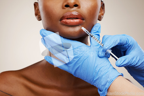Image of Closeup, black woman and needle with plastic surgery, healthcare and cosmetics on a white studio background. African person, girl and model with injection, hands and gloves with wellness and skincare