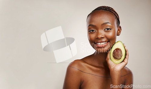 Image of Avocado, beauty and portrait of woman in studio for detox, mockup space and background. Face of happy african model, natural skincare and fruit for vegan cosmetics, sustainable diet or benefits