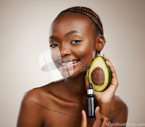 Image of Black woman, portrait and avocado oil with product, natural beauty and skincare with vegan cosmetics on brown background. Smile for dermatology, bottle with vegetable for liquid or serum in studio