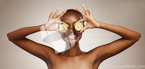 Image of Kiwi, smile and a black woman on a studio background for nutrition, dermatology and a glow. Happy, hands and an African person or model with fruit for health, diet and an organic snack for vitamin c