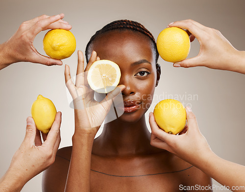 Image of Hands, lemon and natural beauty, black woman in portrait for wellness and sustainable skincare on brown background. Health, nutrition and fruit, dermatology and vegan product with vitamin c in studio