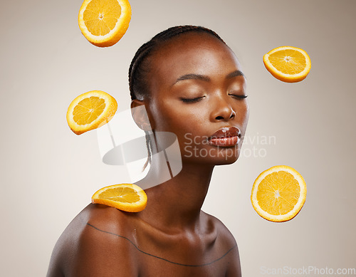 Image of Black woman, skincare and face with orange, vitamin c and cosmetics for healthy skin, eyes closed and facial treatment. Wellness, glow and dermatology for natural ingredients, vegan care and citrus