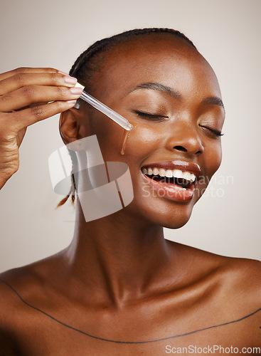 Image of Happy woman, skincare and serum on face in studio for beauty, dermatology or collagen on brown background. African model, facial cosmetics and liquid dropper of hyaluronic acid, essential oil or glow