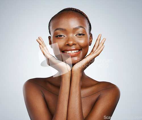 Image of Portrait, smile and beauty with skincare and black woman in studio on a gray background for touch or natural wellness. Frame, spa or luxury and a young model with cosmetic or antiaging treatment