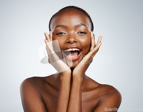 Image of Portrait, skincare and hands on the cheek of a black woman in studio on a gray background for beauty or natural wellness. Face, spa or luxury and a young model with cosmetic or antiaging treatment