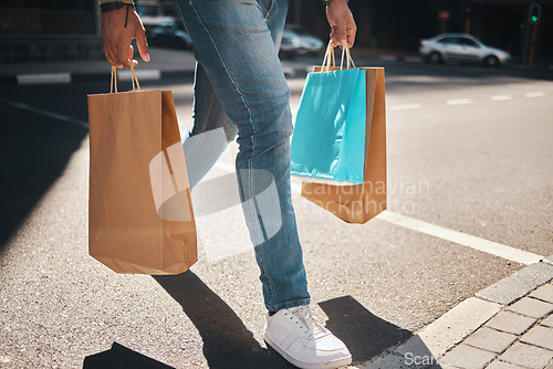 Image of Legs, shopping bag and city person walking, travel and carry retail package, sales product and on outdoor journey. Urban foot steps, commerce market and person commuting with store discount purchase
