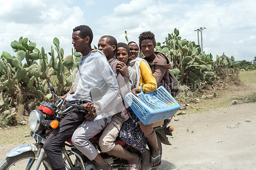 Image of Ordinary people, family travel on bike in Ethiopian countryside.