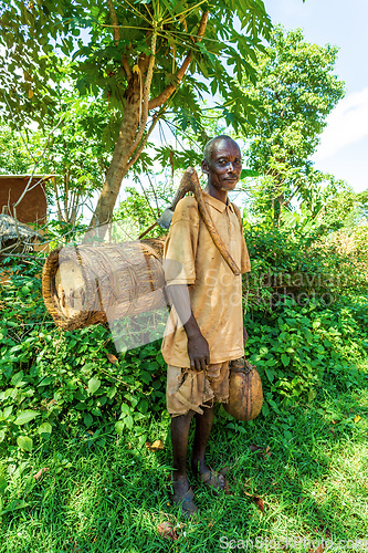 Image of Ethiopian farmer with a bee hive and an primitive ax, Southern Nations , Ethiopia