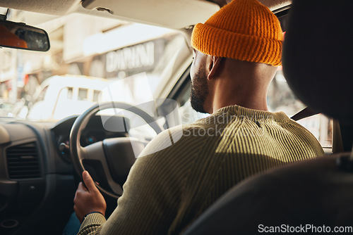 Image of Driving, travel and a man in a car on the street in the city for traveling, driver and a commute. Back, seat and a person in transportation or a vehicle for transport on the road for a journey