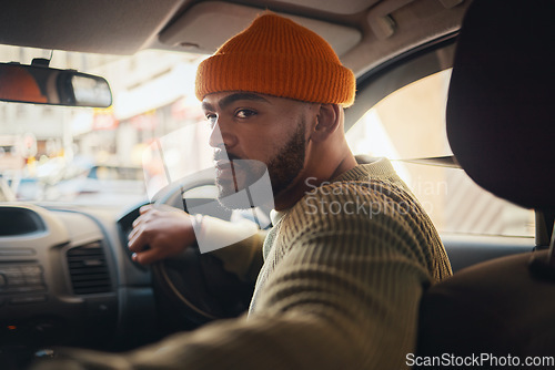 Image of Taxi, ride and man driving in a car as city transport or vehicle travel to a destination in town and looking for parking. Serious, back and person in lift service reverse in a street or location