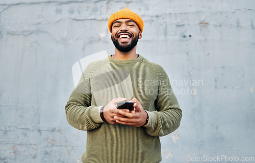 Image of Cellphone, smile and portrait of man by wall networking on social media, mobile app or internet. Technology, happy and person from Colombia scroll on website with cellphone in city by gray background