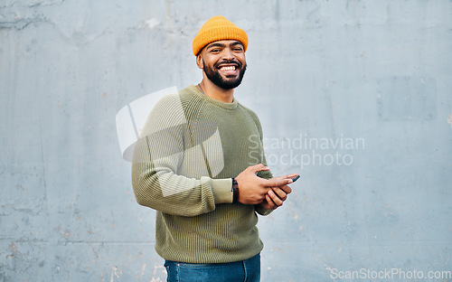 Image of Phone, smile and portrait of man by wall networking on social media, mobile app or the internet. Technology, happy and person from Colombia scroll on website with cellphone in city by gray background