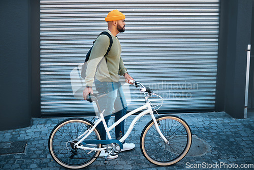 Image of City, walking and man with bike for eco friendly transport to university in morning street. Urban sidewalk, carbon neutral commute and college student with bicycle, backpack and sustainable travel.