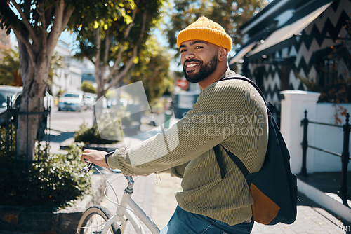 Image of Bicycle, fashion and portrait of man in city for commute, adventure and journey in urban town. Fashion, style and happy person on bike for eco friendly transport, carbon footprint and cycling in road