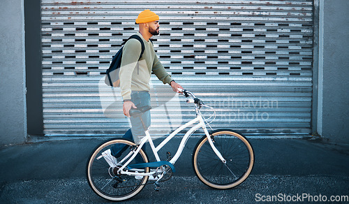 Image of City, walk and man with bike in street for eco friendly transport to university in morning. Urban sidewalk, carbon neutral commute and college student with bicycle, backpack and sustainable travel.