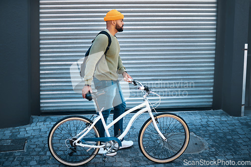 Image of City, walking and man with bicycle in street for eco friendly transport to university in morning. Urban sidewalk, carbon neutral commute and college student with bike, backpack and morning travel.