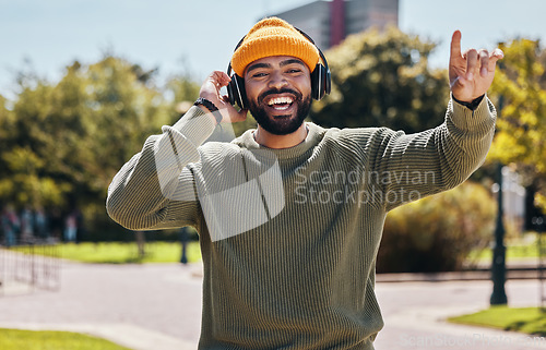 Image of Music, headphones and portrait of happy man at park outdoor, listening to audio online or hearing sound on podcast technology. Face, streaming radio and person dance in garden for freedom in nature