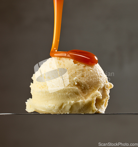 Image of caramel sauce pouring on vanilla ice cream