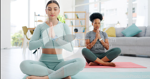 Image of Women friends, yoga and meditation with namaste on floor, peace or zen fitness in home living room. Girl, personal trainer and exercise for health, workout or prayer hands in lounge for mindfulness