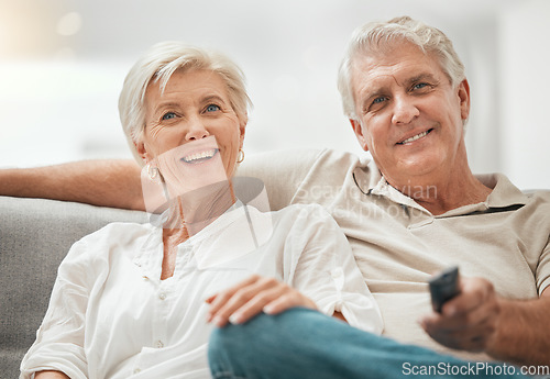 Image of Happy senior couple, watching TV and relax on sofa for living room entertainment or streaming at home. Mature man and woman smile for series, shows or channels with remote on lounge couch in house